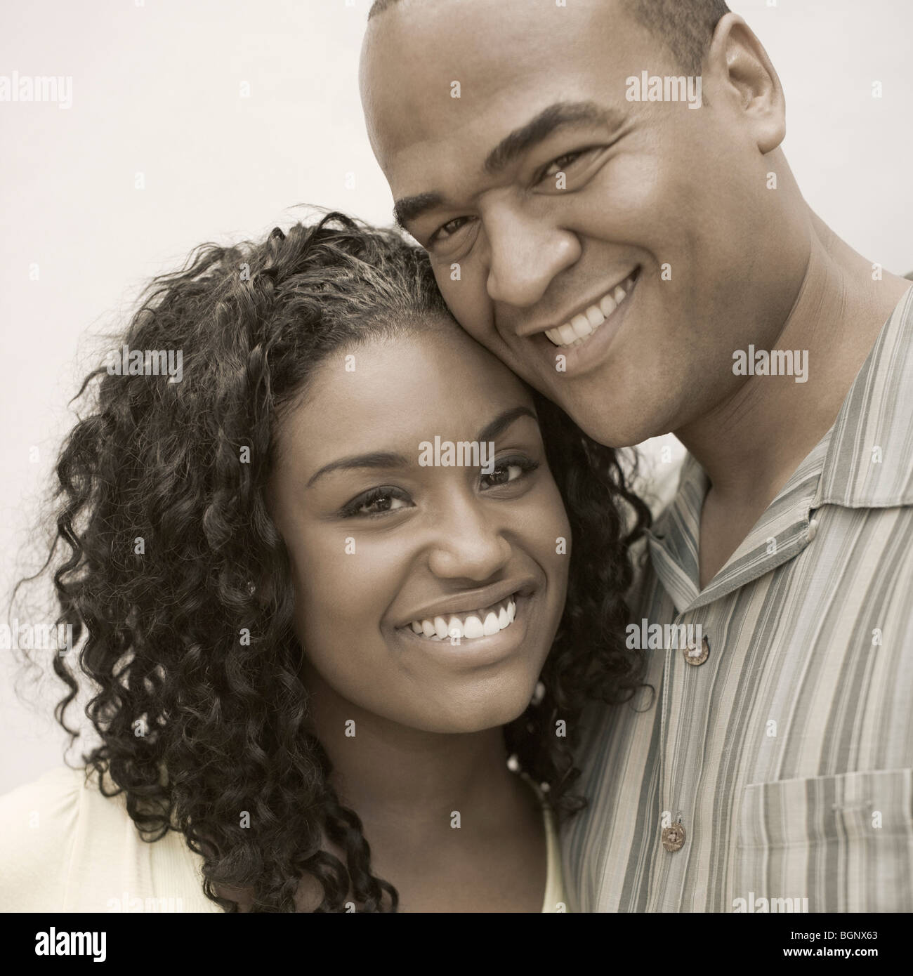 Portrait of a young woman and a mid adult man smiling Stock Photo - Alamy