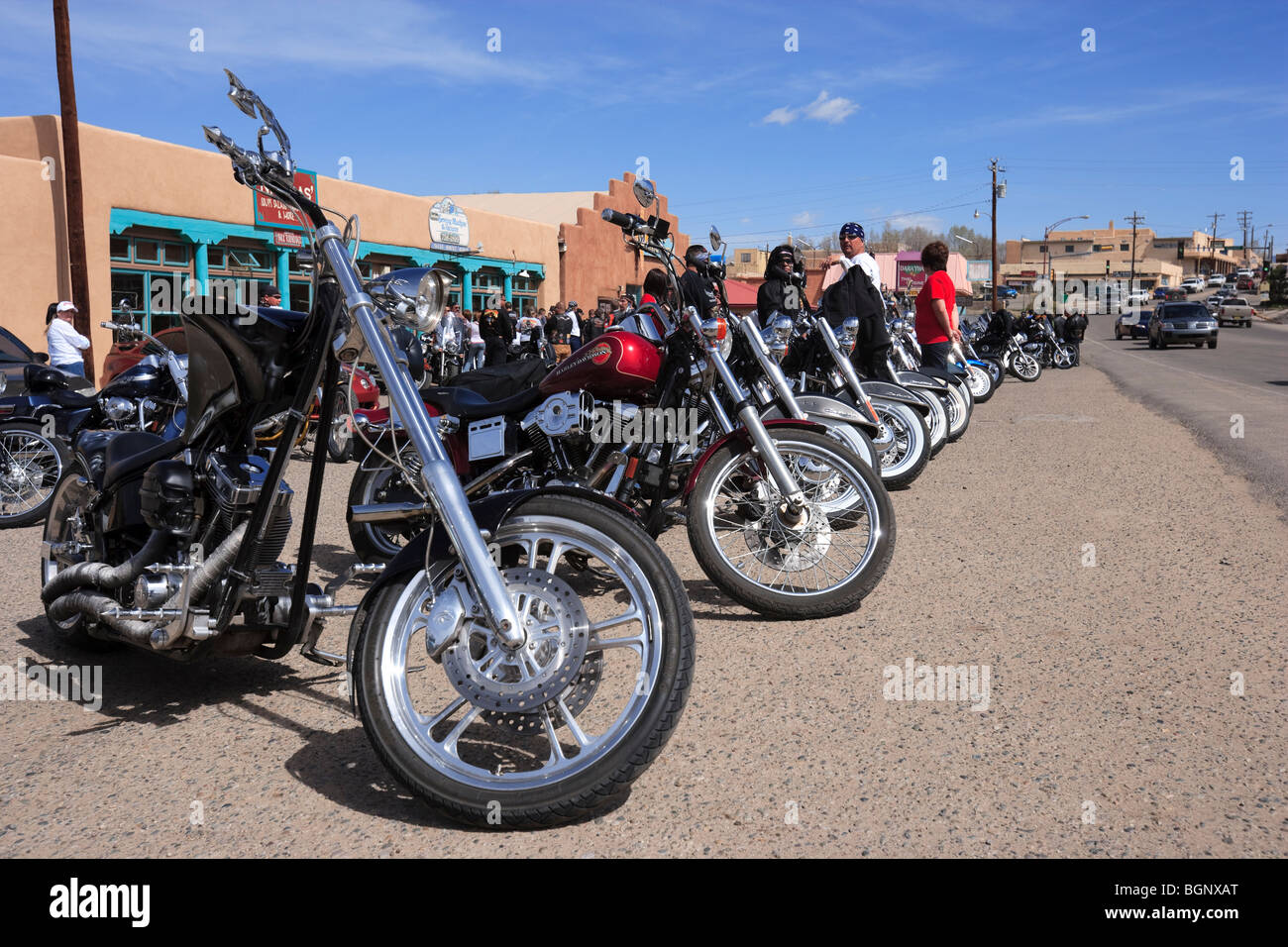 Bikers with motorbikes lined up outside Dave's custom cycle shop Paseo Del Pueblo Sur Taos, New Mexico. USA Stock Photo