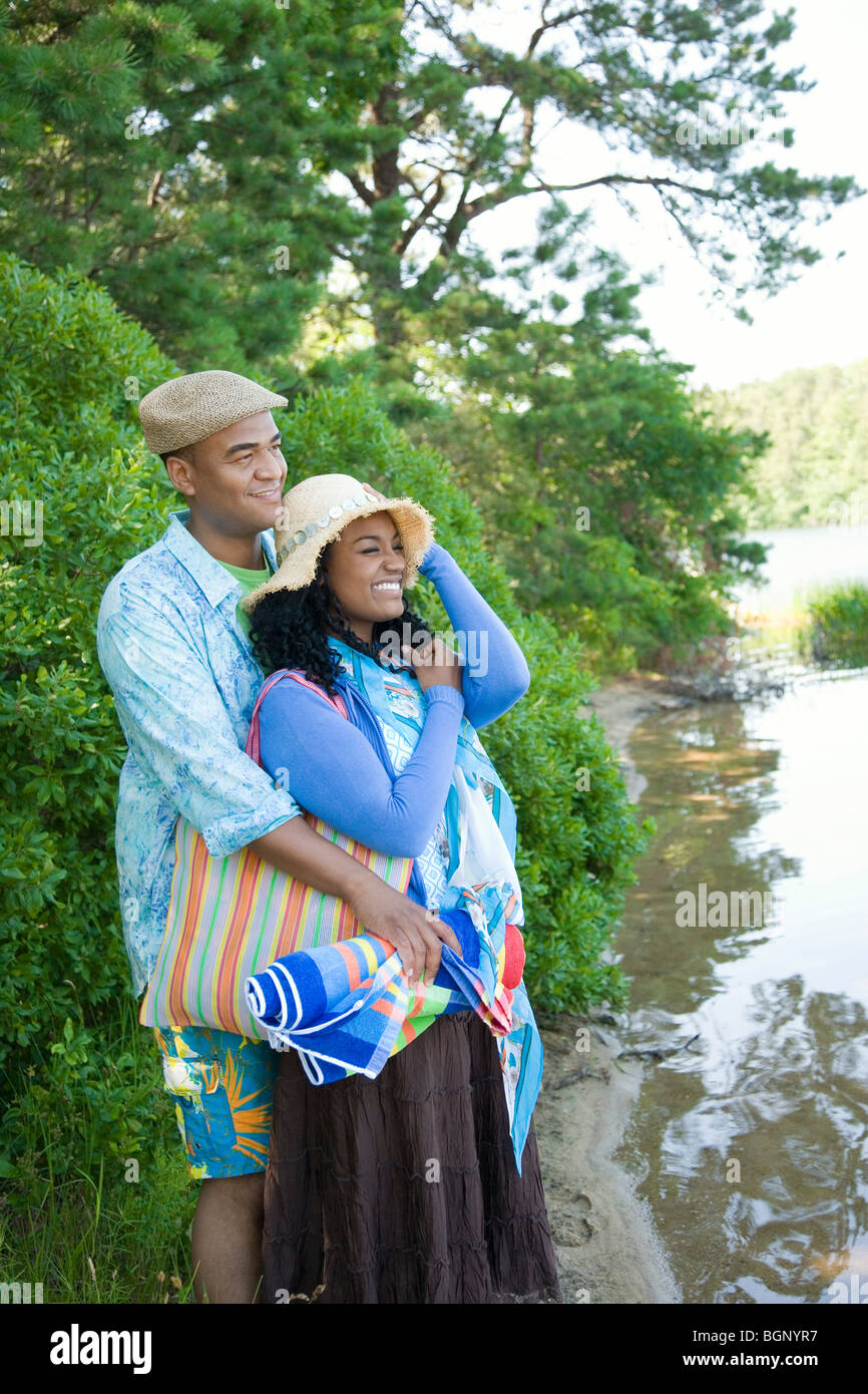 Mid adult man embracing a young woman from behind Stock Photo - Alamy
