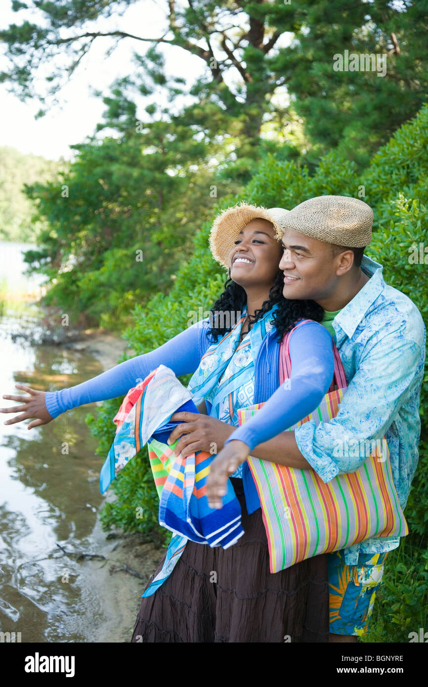 Mid adult man embracing a young woman from behind Stock Photo - Alamy