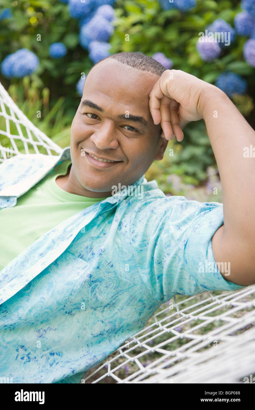 Mid adult man lying in hammock hi-res stock photography and images - Alamy
