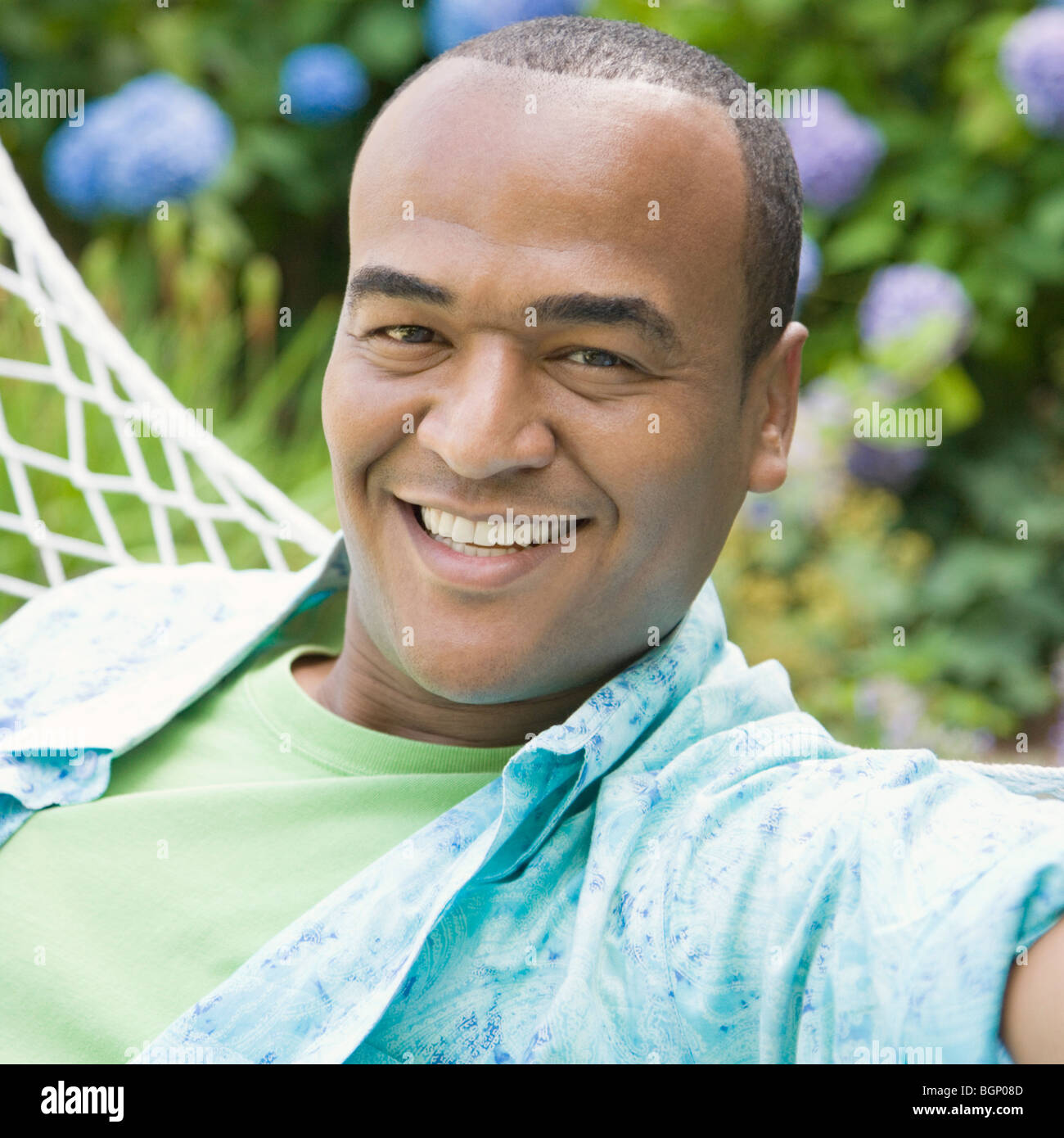 Portrait of a mid adult man lying in a hammock and smiling Stock Photo ...