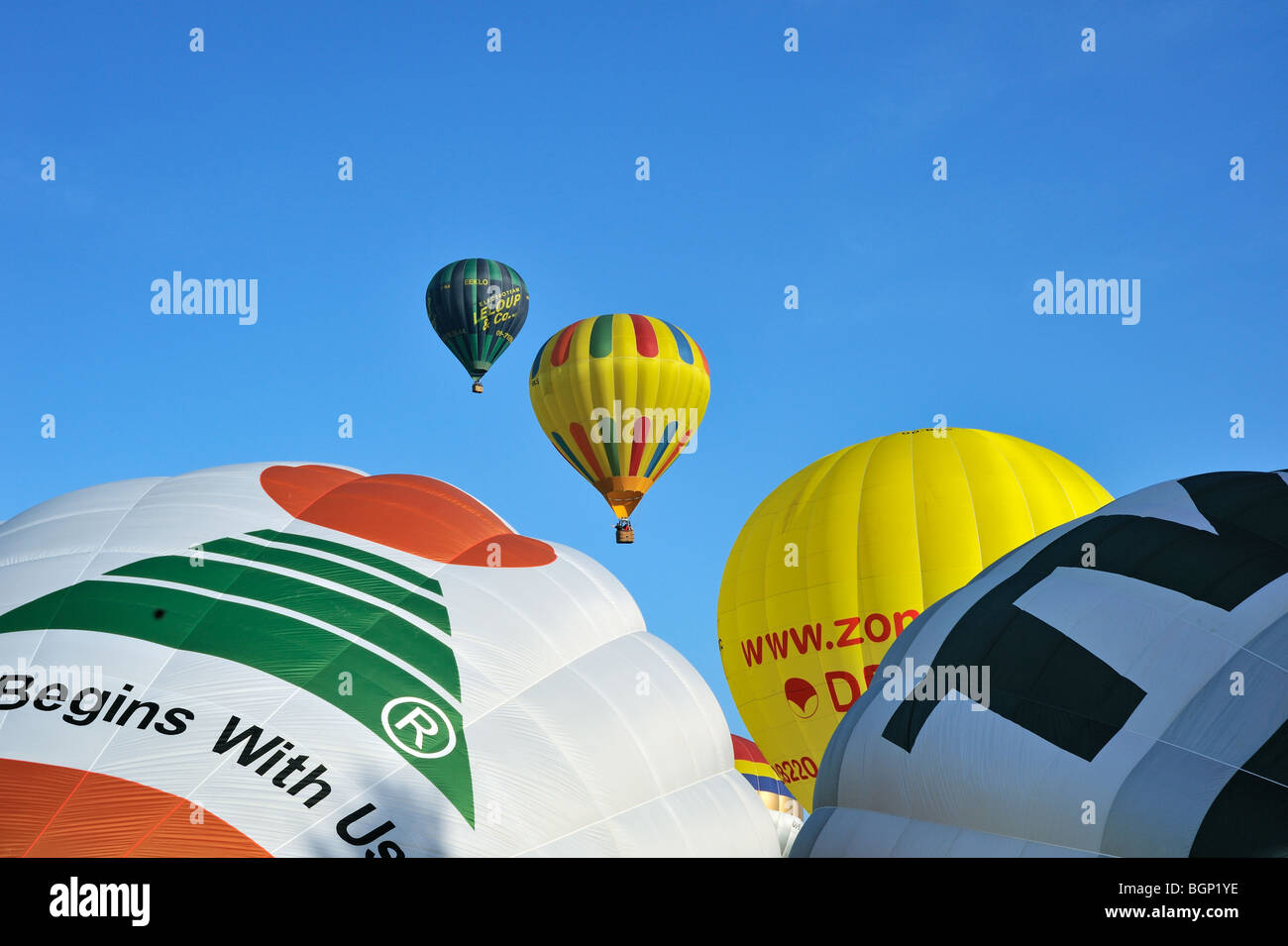 Balloonists / Aeronauts flying with hot-air balloons during hot air ballooning meeting Stock Photo