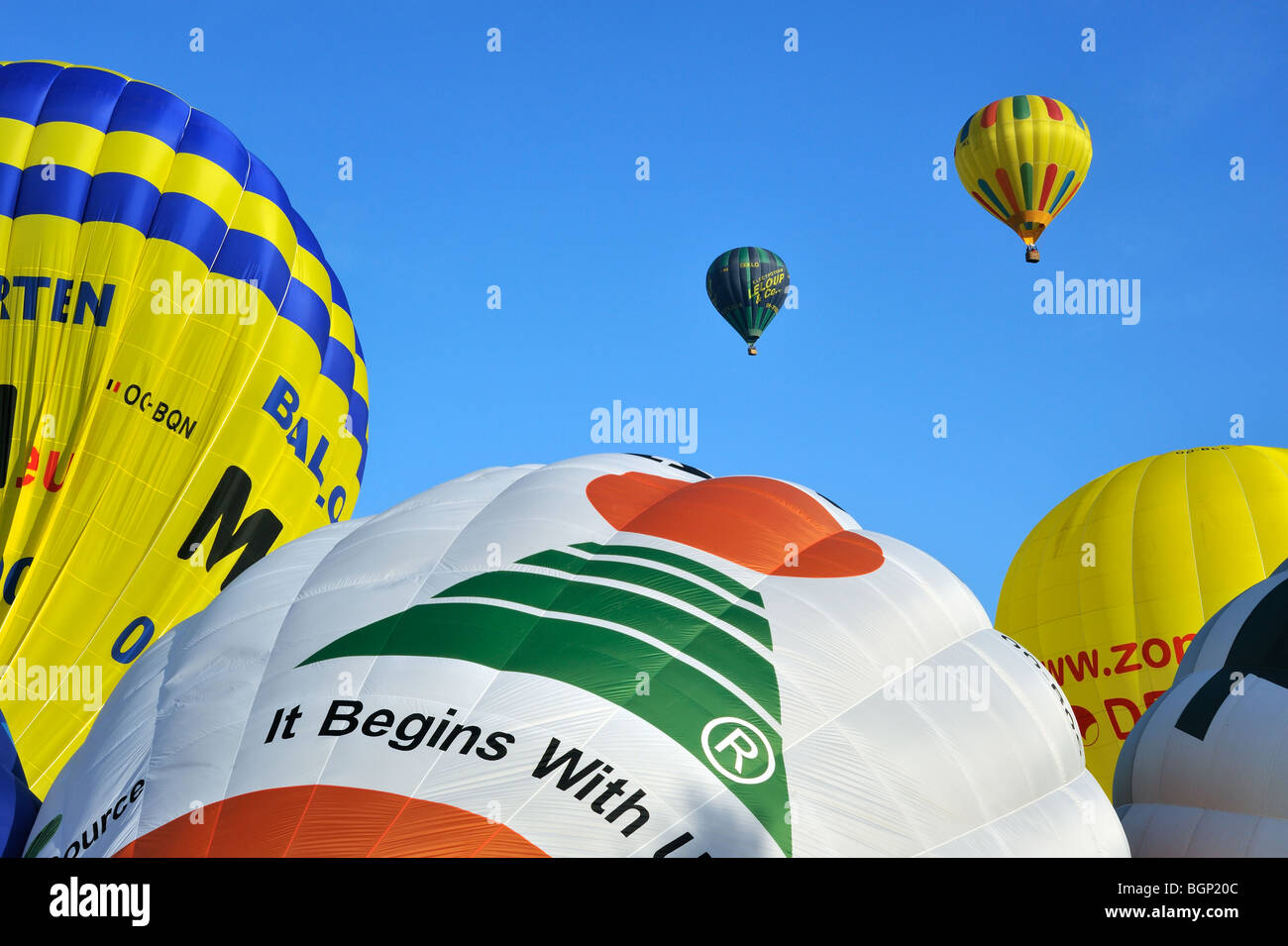 Balloonists / Aeronauts flying with hot-air balloons during hot air ballooning meeting Stock Photo