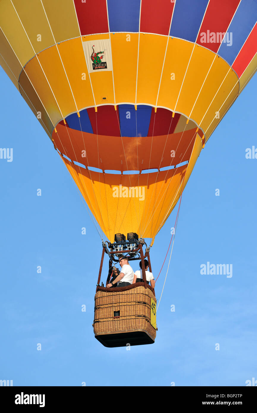 Balloonists / Aeronauts flying in hot-air balloon during ballooning meeting Stock Photo