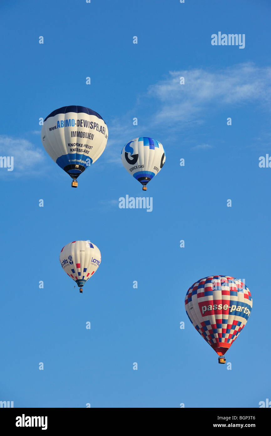 Balloonists / Aeronauts are taking off with hot-air balloons during ballooning meeting Stock Photo