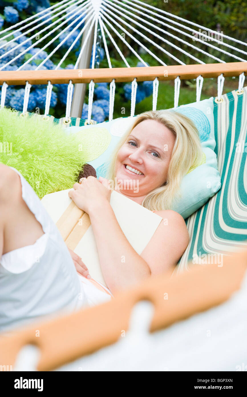 Portrait of a mid adult woman lying in a hammock and smiling Stock ...