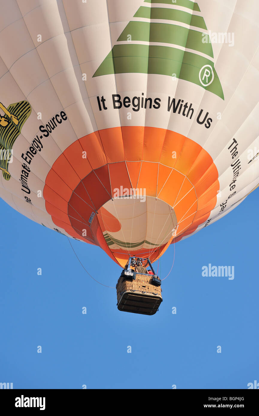 Balloonists / Aeronauts are taking off with hot-air balloon during ballooning meeting Stock Photo