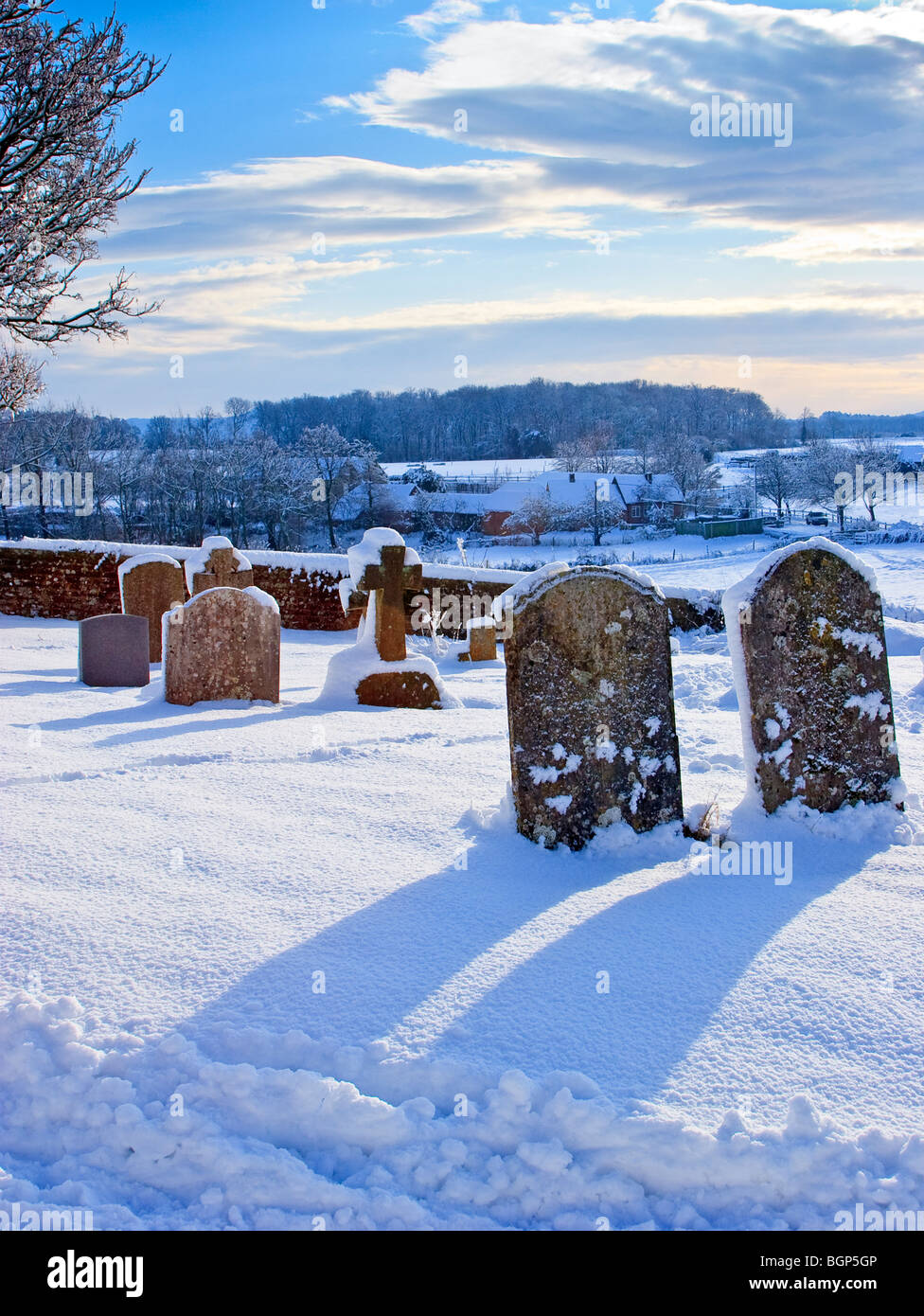 A winters sunset at St Mary's Church graveyard, Thakeham, West Sussex England Great Britain UK 2010 Stock Photo