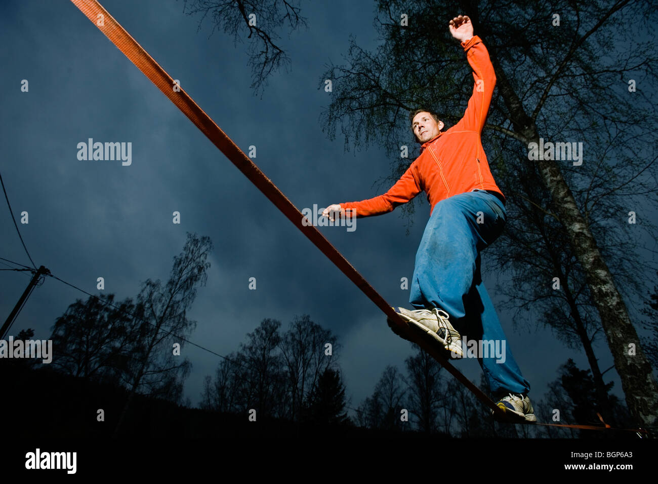 A man balancing on a cord. Stock Photo