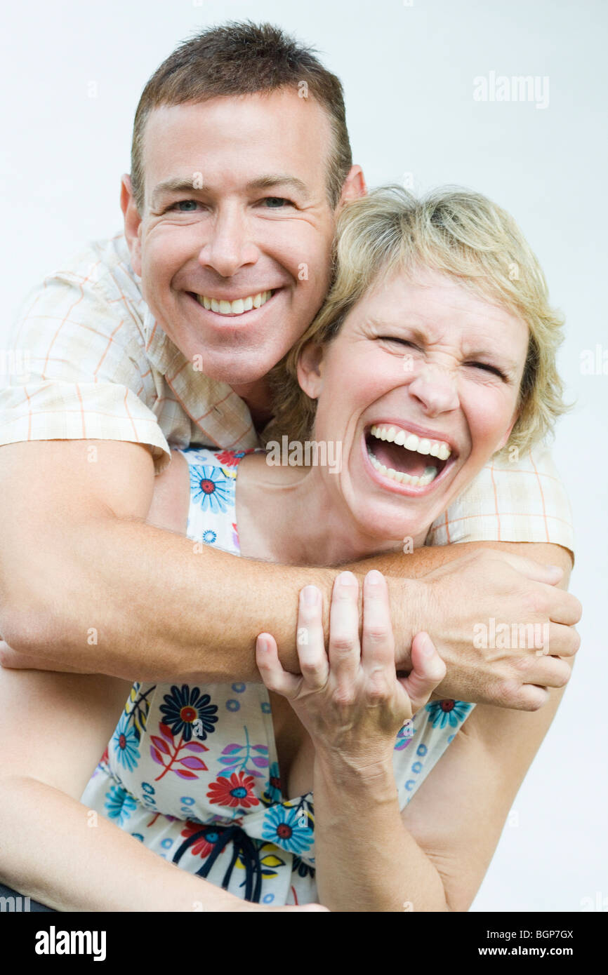 Portrait of a mature man embracing a mature woman from behind and