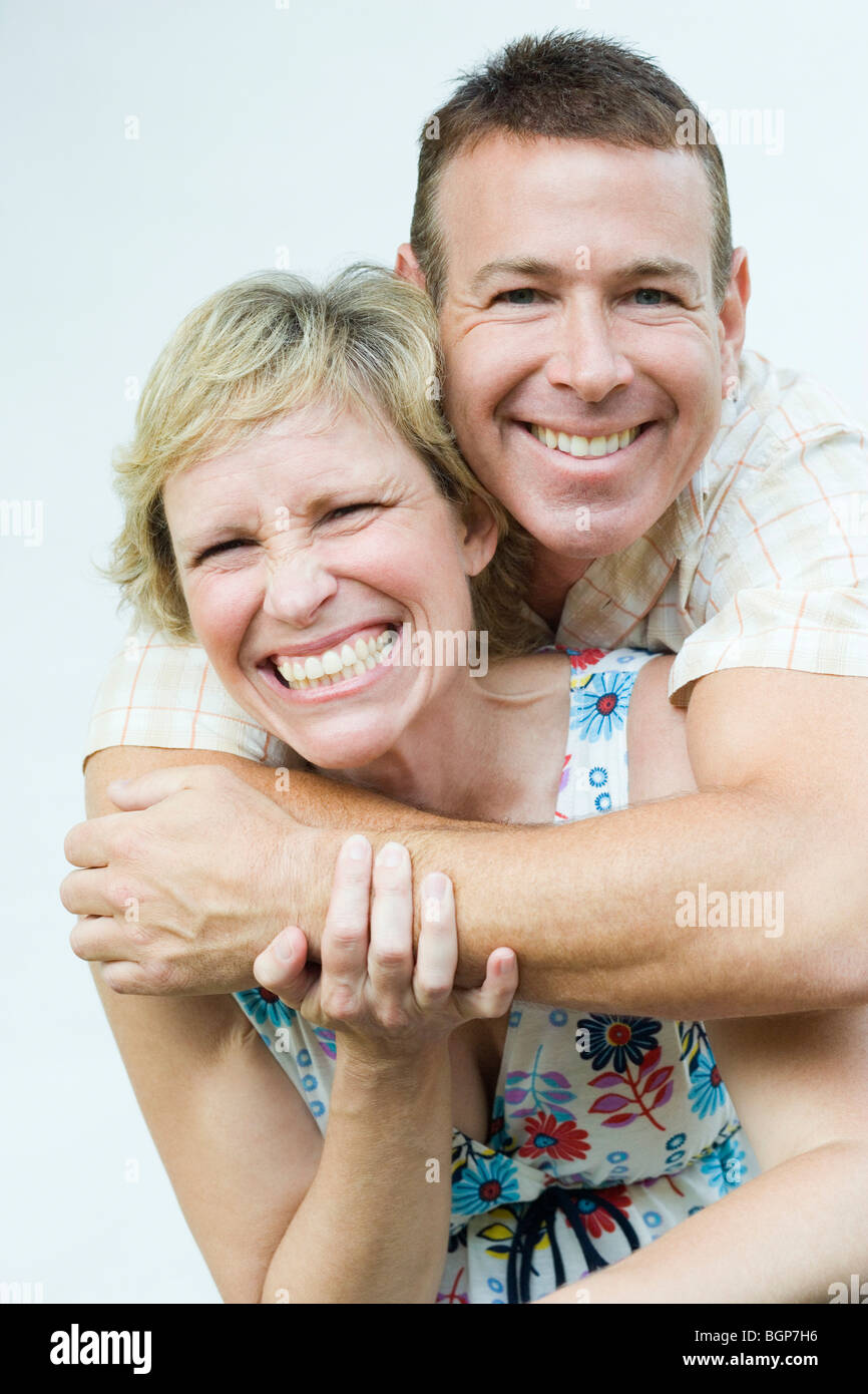 Portrait of a mature man embracing a mature woman from behind and ...