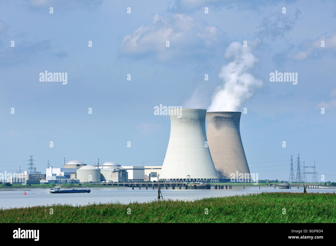 Power lines and the cooling towers of the Doel Nuclear Power Station along the river Scheldt in Antwerp, Belgium Stock Photo