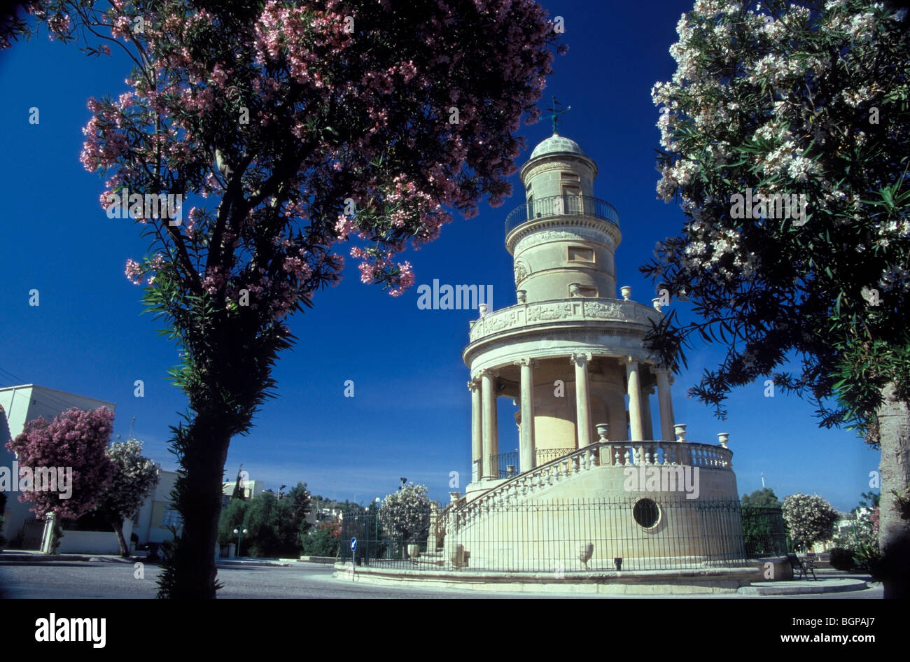 Malta, an atmospheric tower in the town of Lija fringed by oleander trees in full colourful flower bloom Stock Photo
