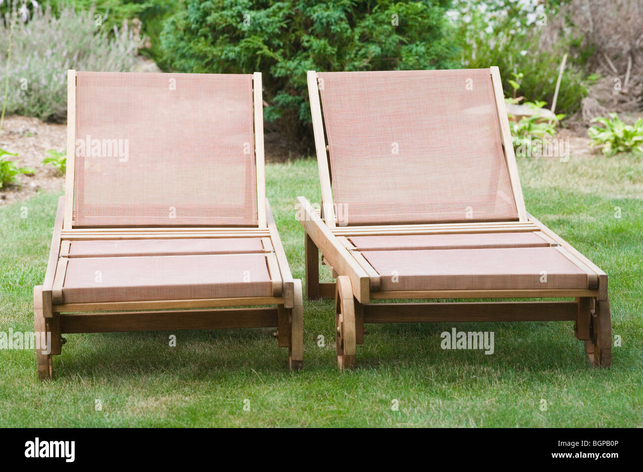 Two lounge chairs in a lawn Stock Photo - Alamy