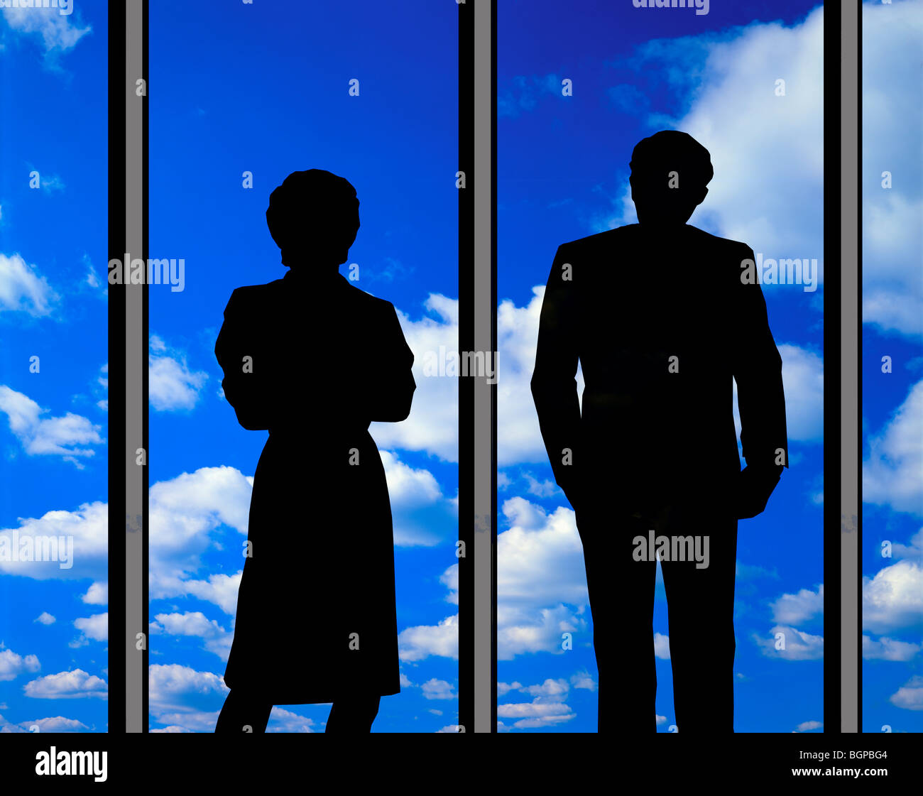 couple looking at clouds through large glass window Stock Photo