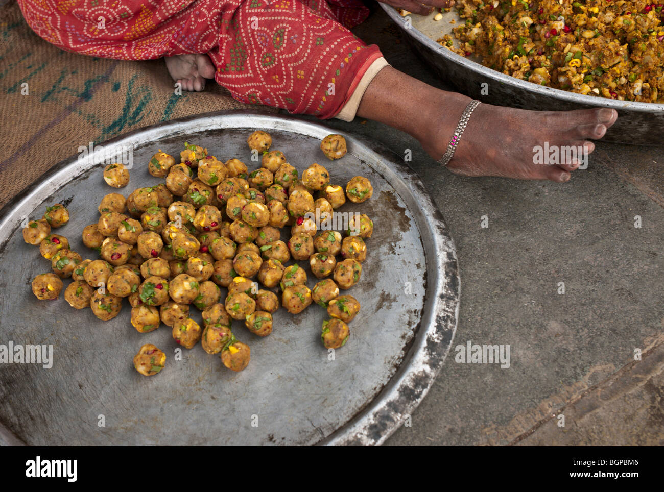 A woman making a chickpea snack in an Hindu temple, Jaipur, India Stock Photo