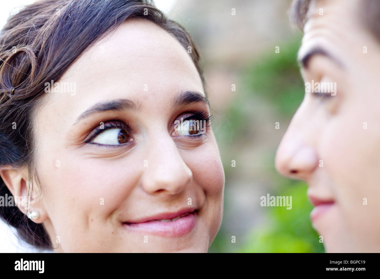 A happy woman looks at a man.  Closeup Stock Photo