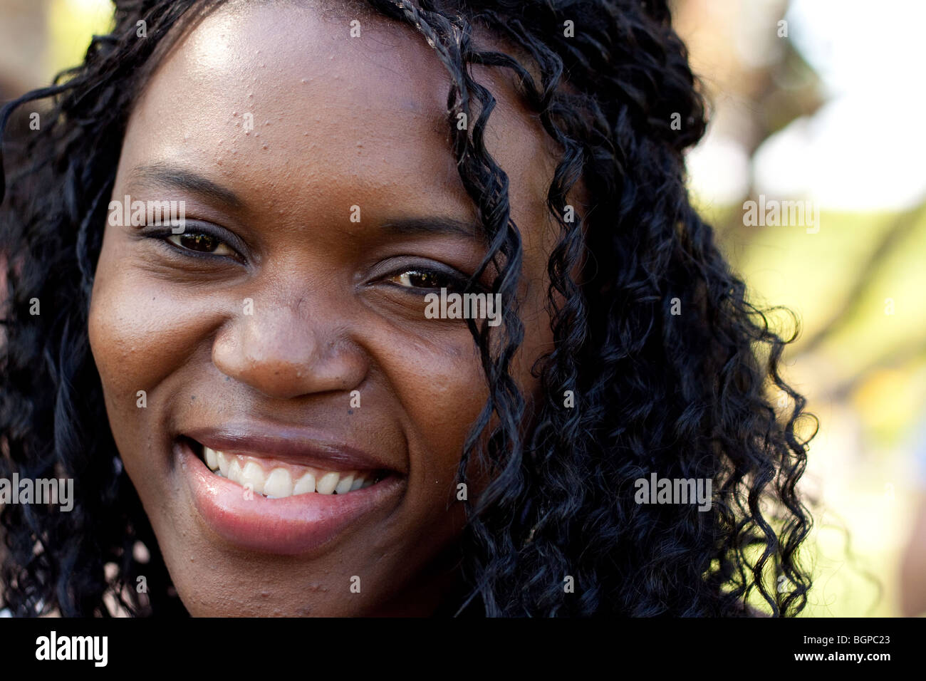 A black woman smiles and looks at the camera Stock Photo - Alamy
