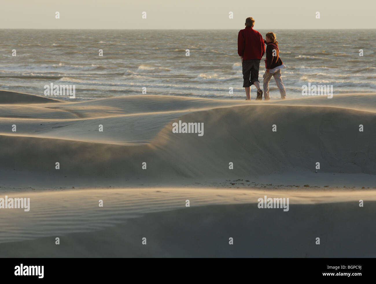 Strollers on beach, Belgium Stock Photo