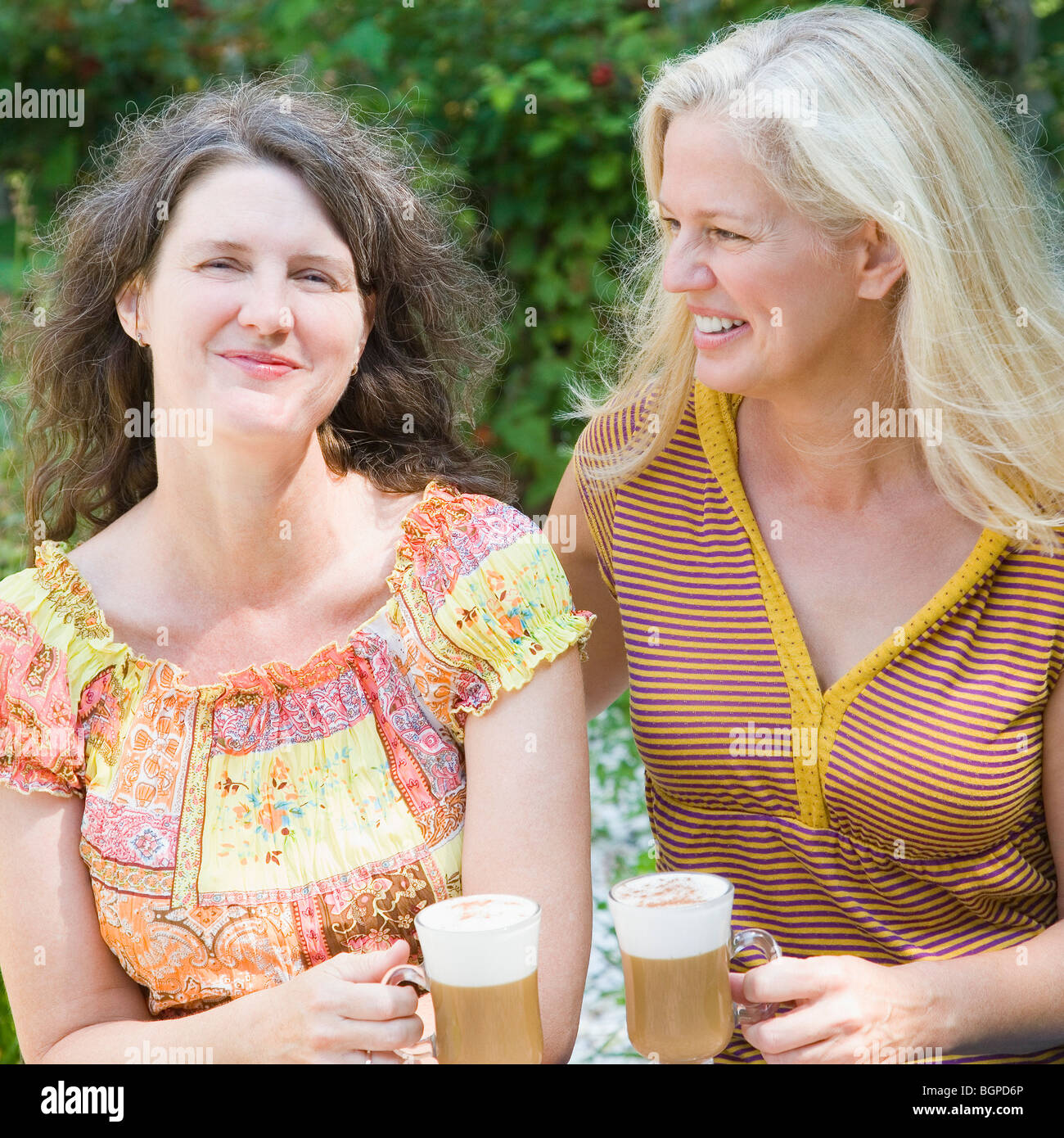 Close up two women holding cups hi-res stock photography and images - Alamy