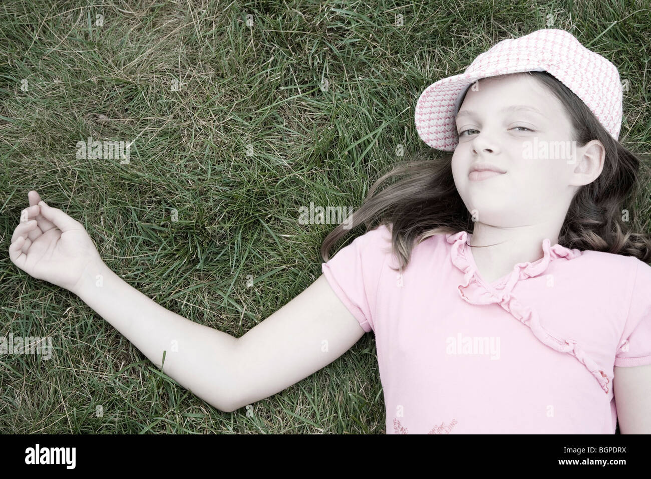 Portrait of a girl lying on grass Stock Photo - Alamy