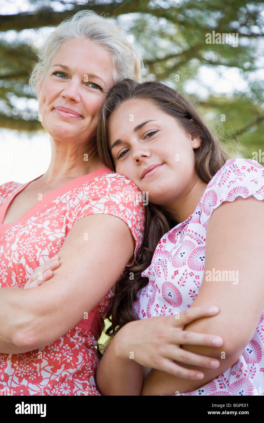 Portrait of a mature woman smiling with her daughter Stock Photo