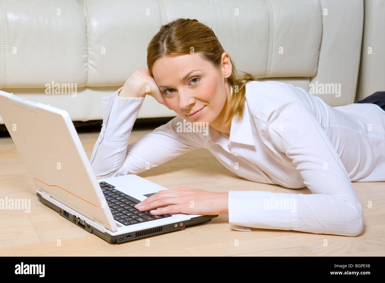 Young woman working with laptop Stock Photo - Alamy