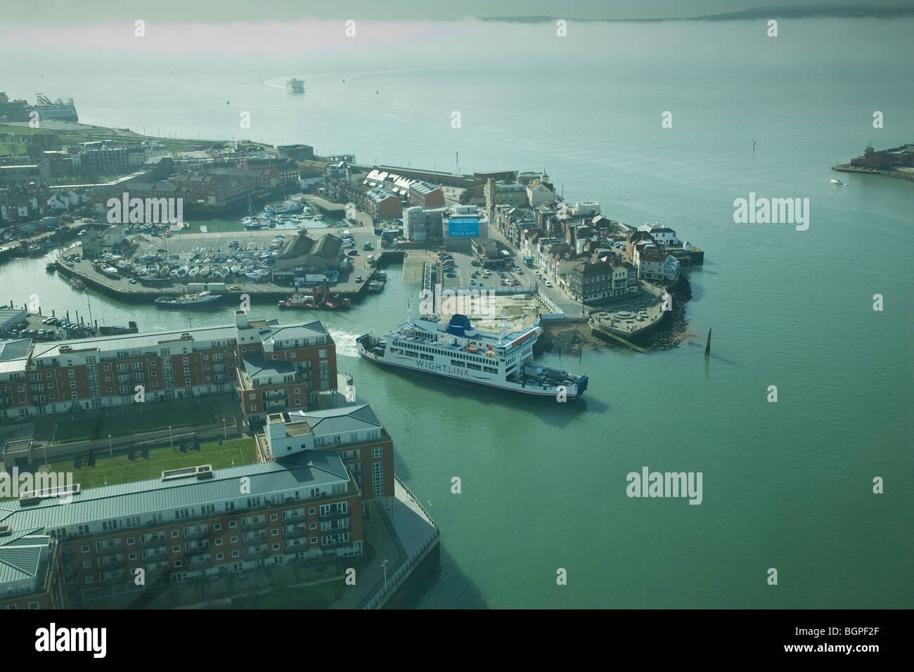 View of Old Portsmouth from the Spinnaker Tower with the Isle of Wight beyond shrouded in early morning mist. Stock Photo