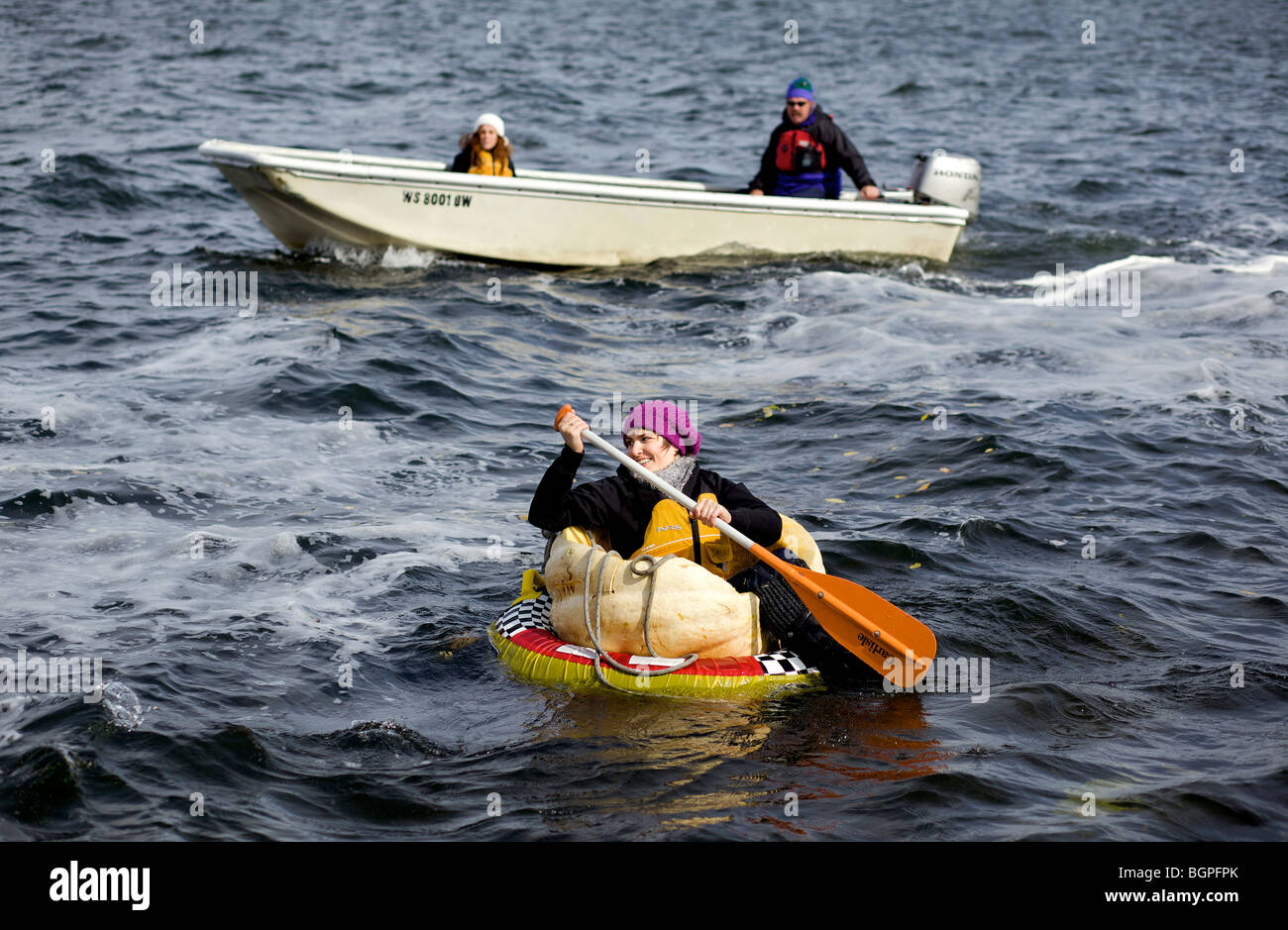 Paddling a pumpkin during a Giant Pumpkin Regatta held in Lake Mendota