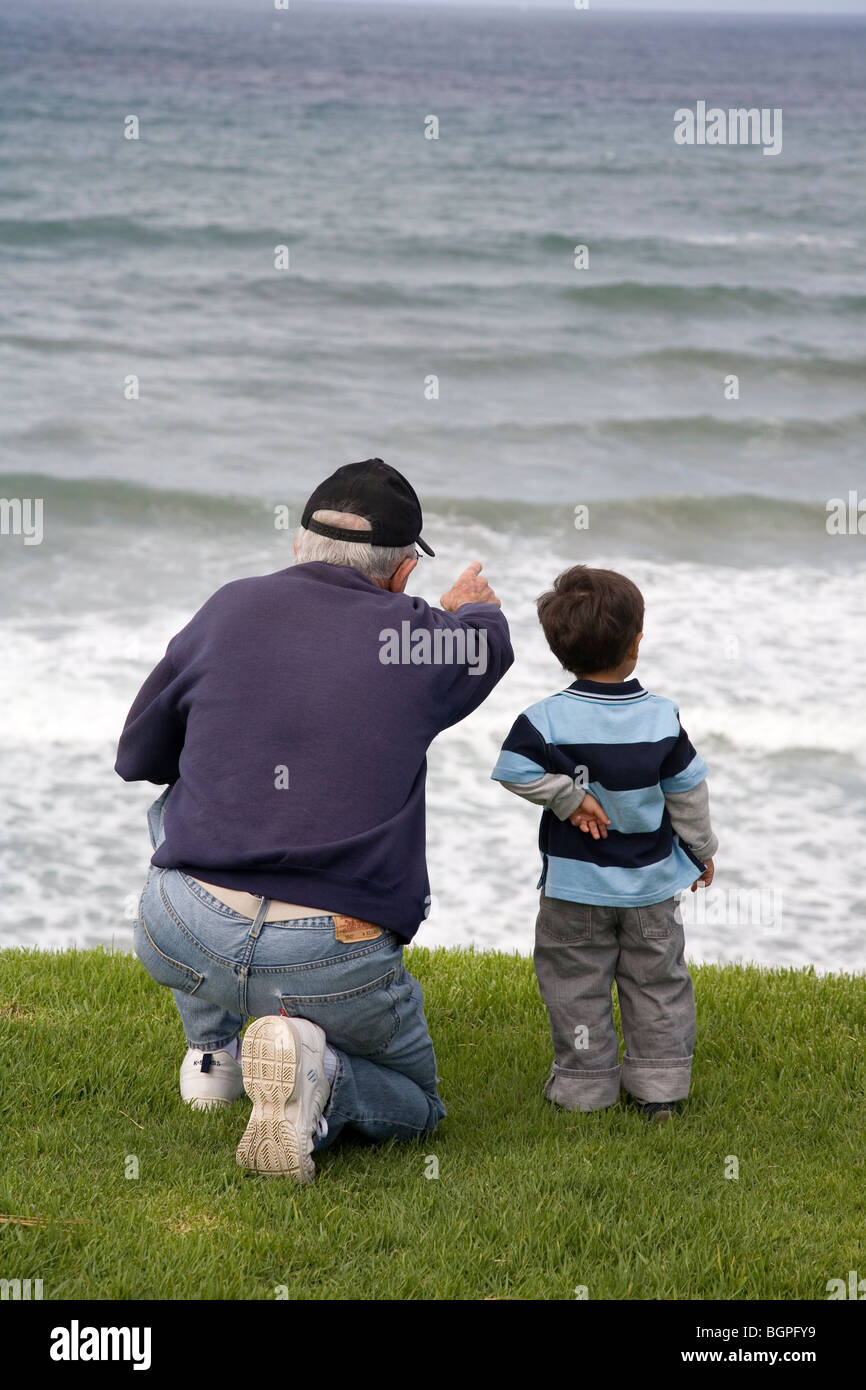 Grandfather and 2 year old Grandson looking at Ocean, San Diego, California Stock Photo
