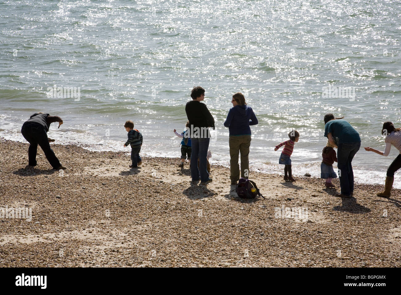 Women and children on the beach near the entrance to Portsmouth Harbour, England. Stock Photo