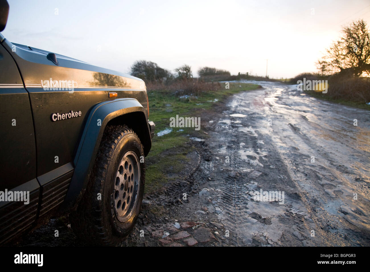 Jeep Cherokee and off road track in the snow, Flooded wheel tracks Stock Photo