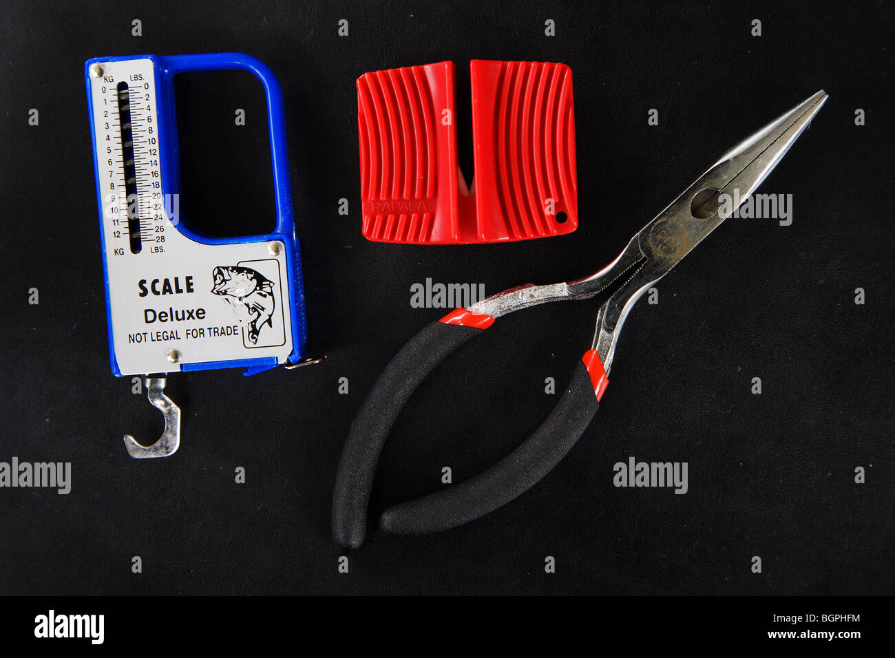 Fishing tools scale pliers knife sharpening loading tackle box preparing for trip Stock Photo