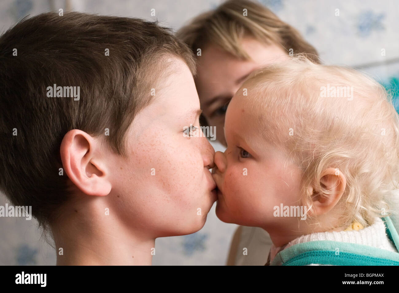 Boy kissing girl on lips in a bath, black girl jewelry