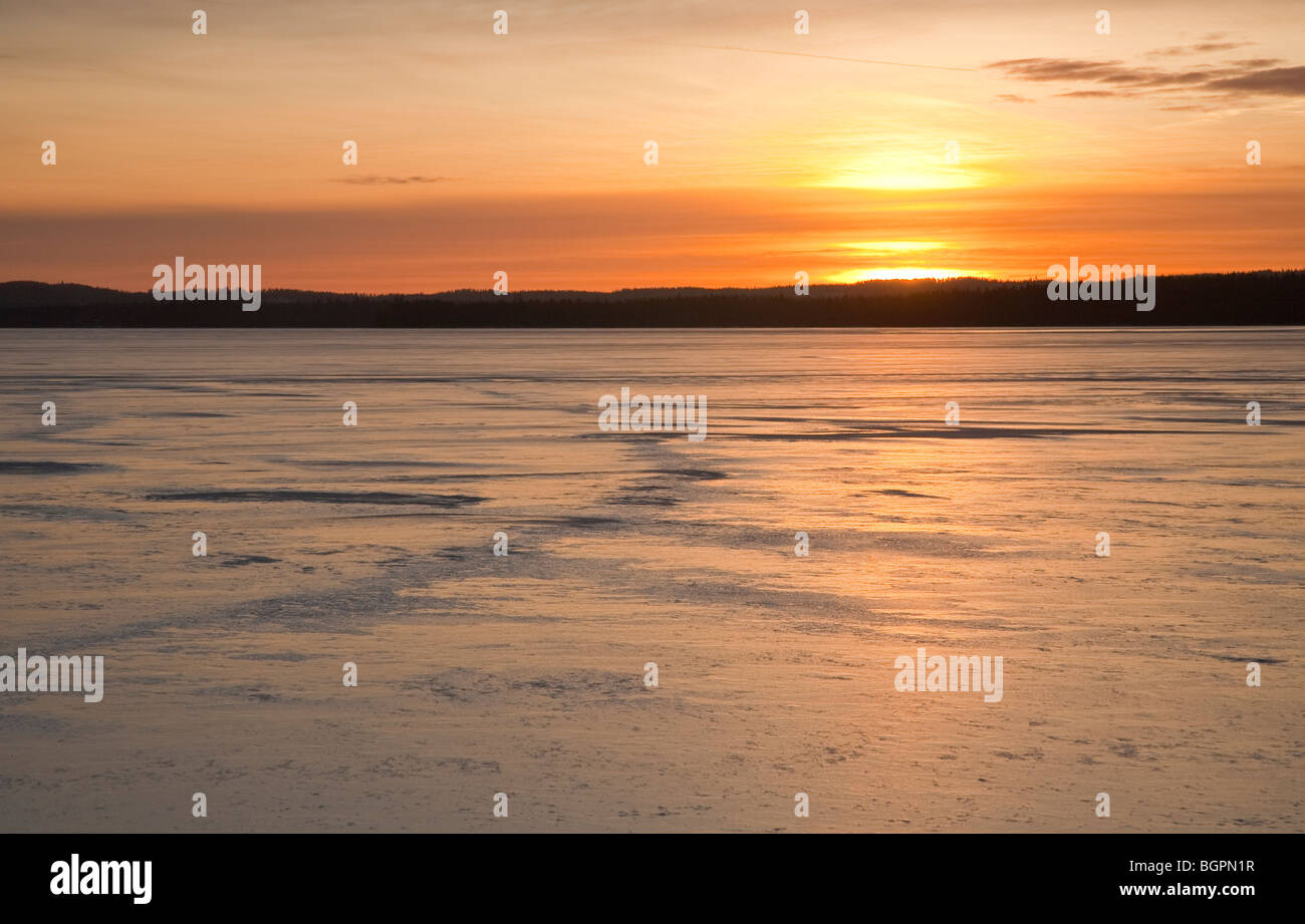 Ice covered lake at sunset at Winter , Finland Stock Photo