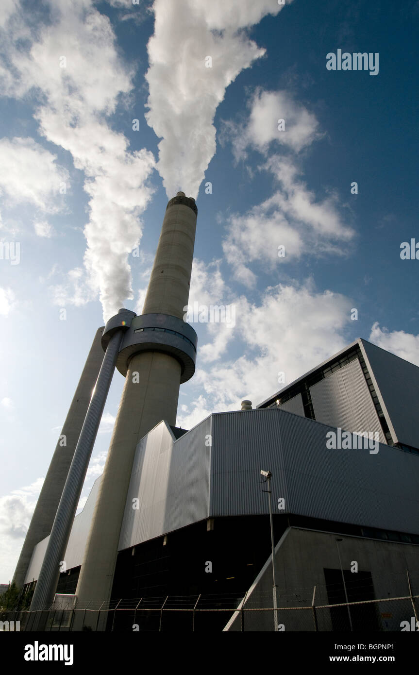 chimney producing smoke in blue sky Stock Photo - Alamy