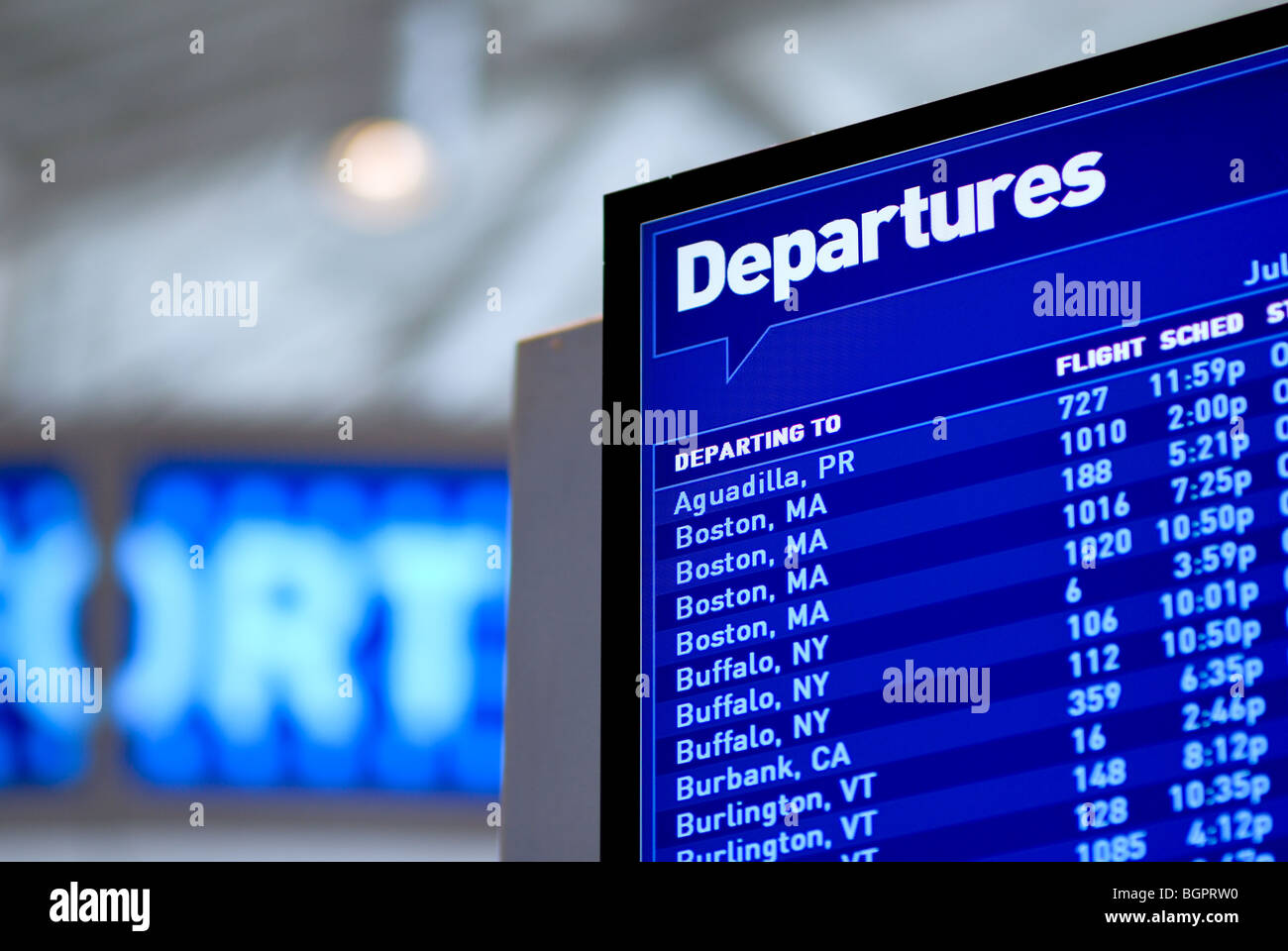 An airport departures board, showing departing flight numbers ,cities, and times. Stock Photo