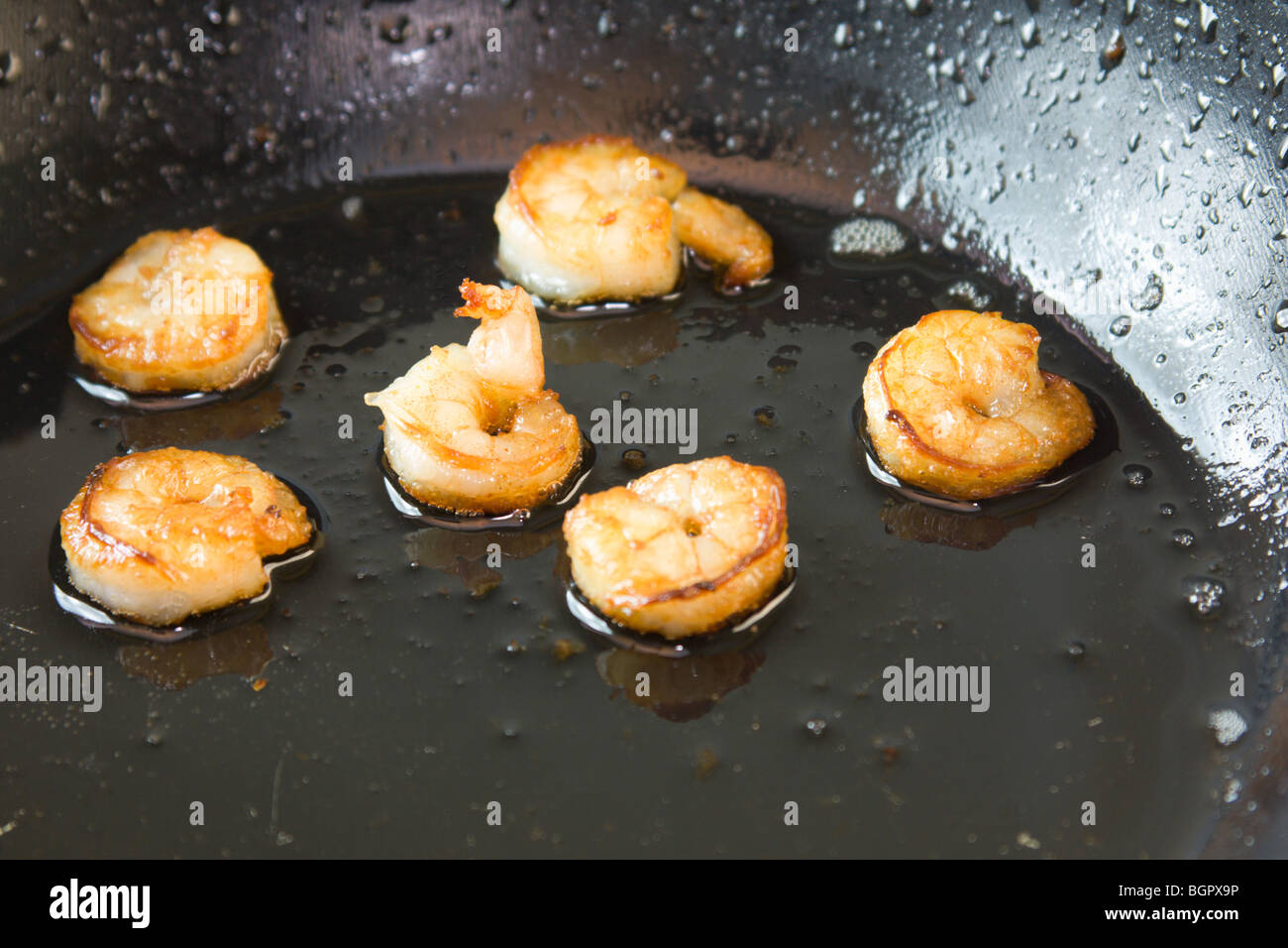 close-up of fresh shrimp frying in olive oil Stock Photo
