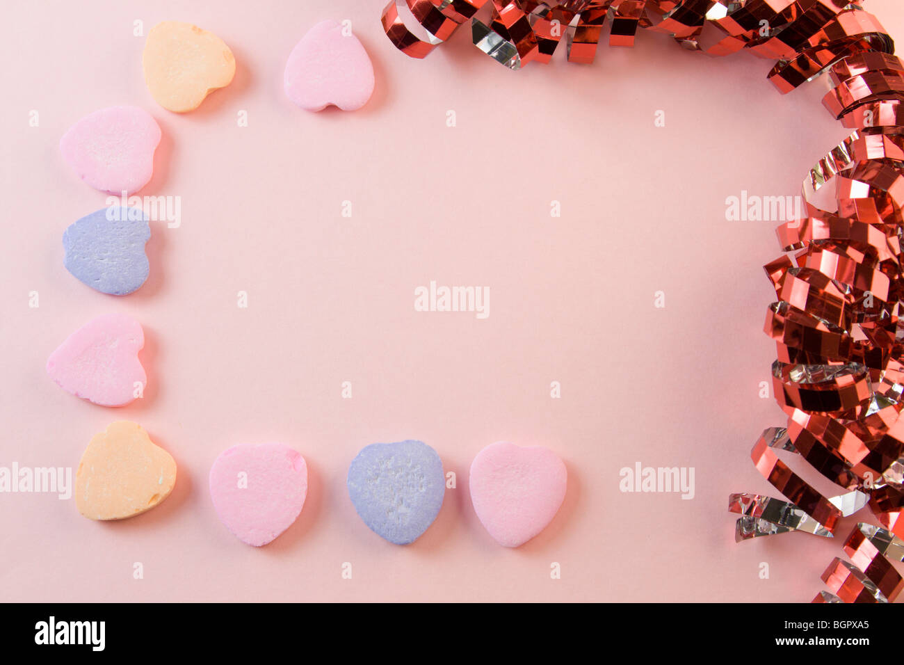 candy heart valentines day frame with pink, purple, and orange hearts Stock Photo