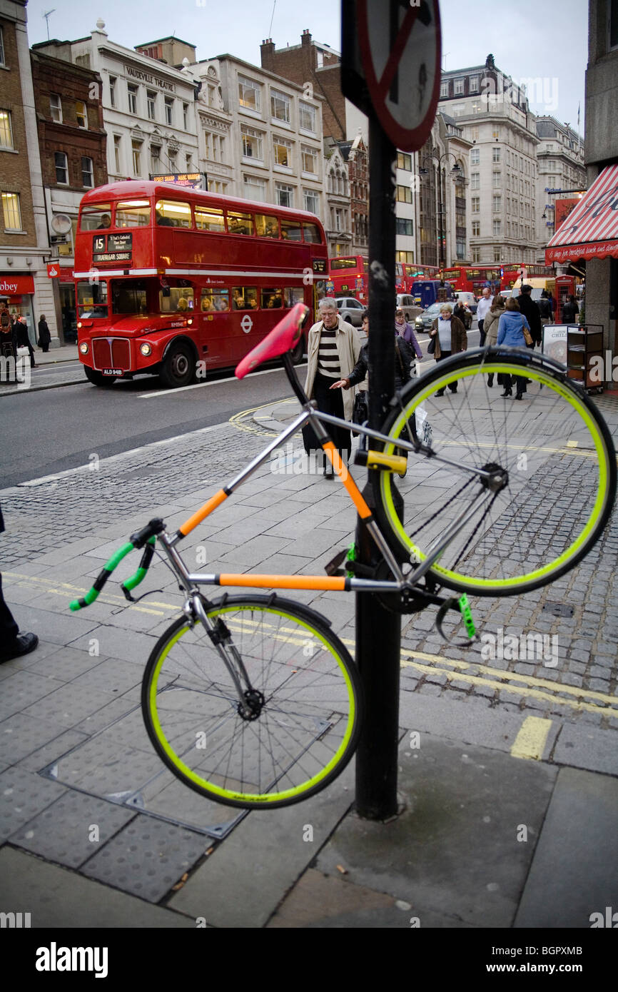Bicycle locked on a street pole the strand London, England, Britain, UK Stock Photo
