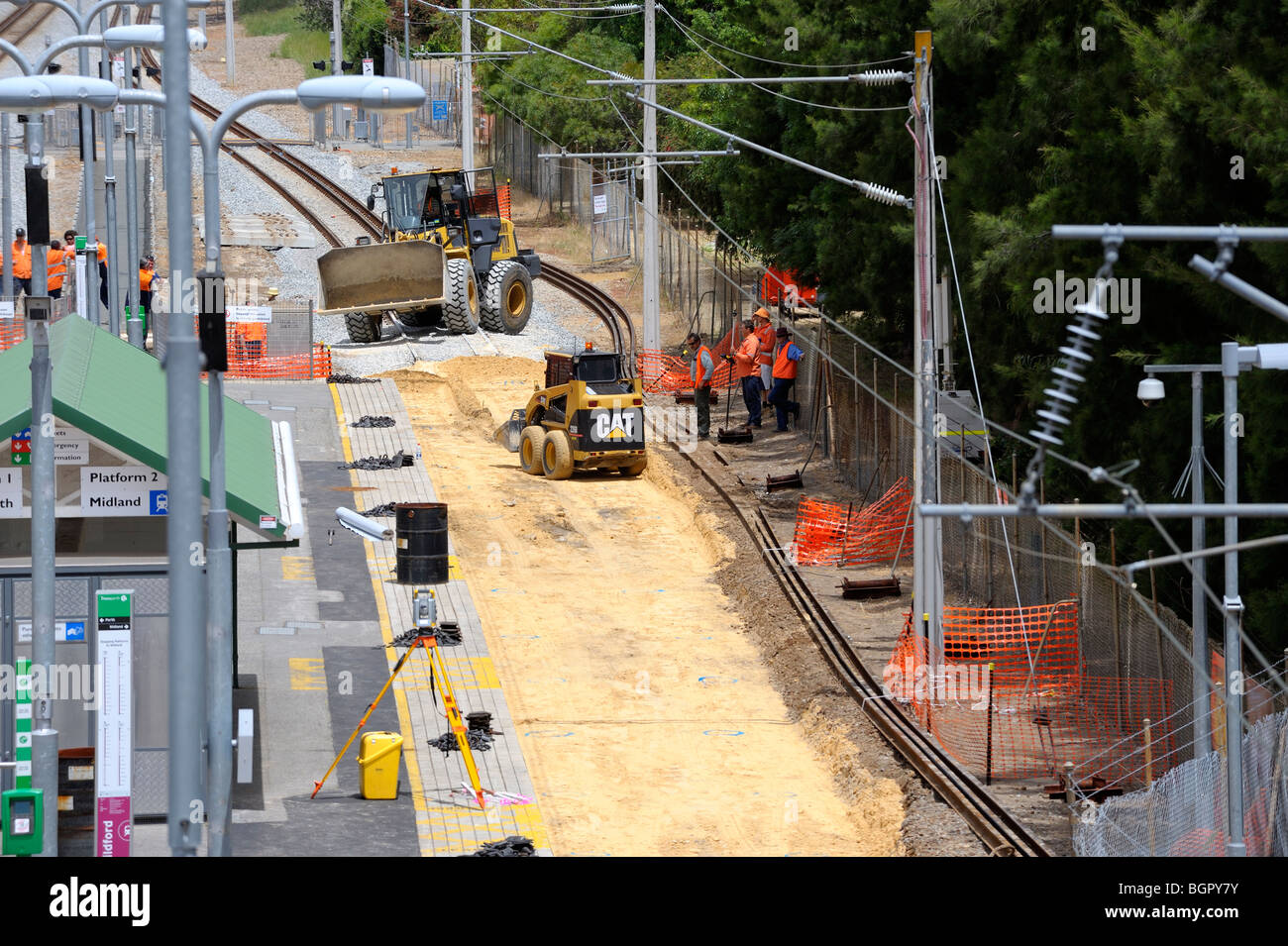 Workmen preparing foundation for new sleepers on suburban railway line. Guildford, Perth, Western Australia Stock Photo