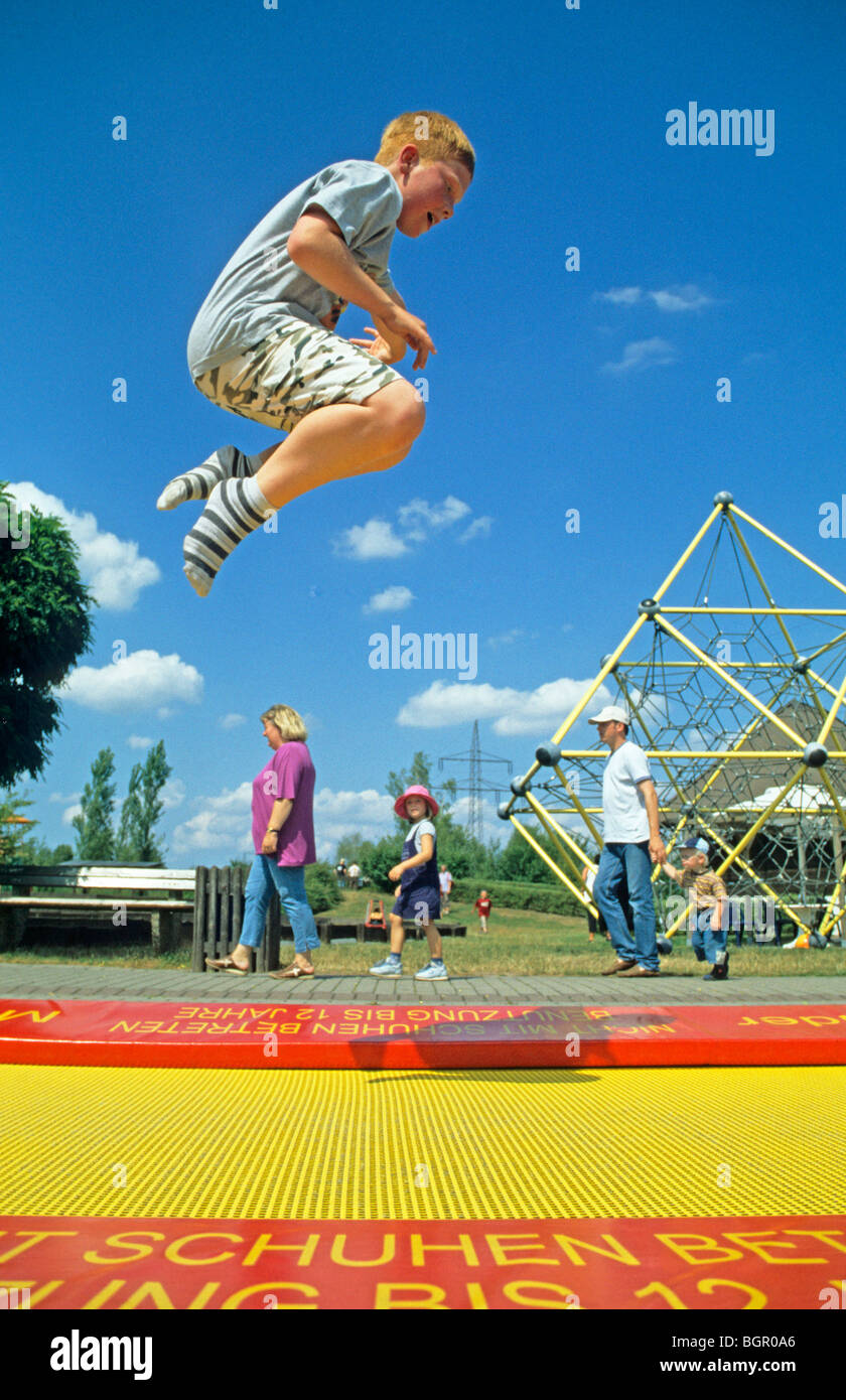 young boy jumping on a trampoline Stock Photo