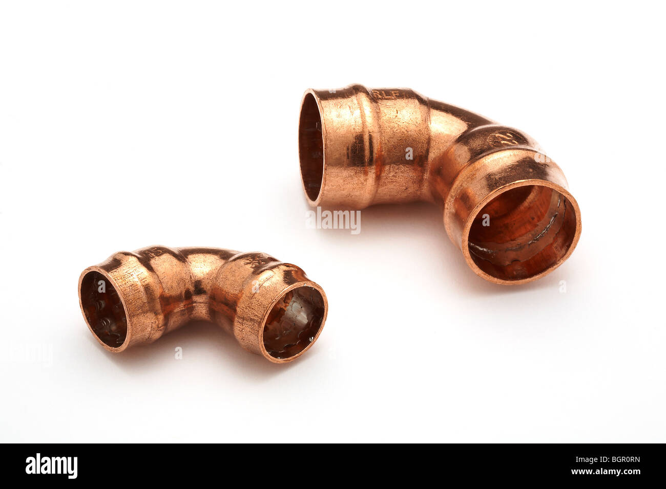 Copper Yorkshire  plumbing solder fittings on white background 15mm and 22mm right angled  elbows Stock Photo