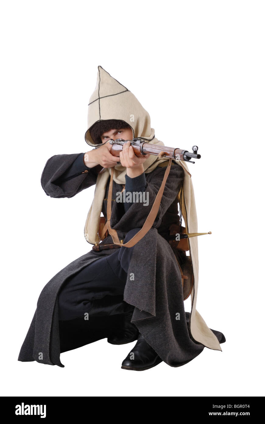 Russian Cossack points a rifle in sitting position. Stock Photo
