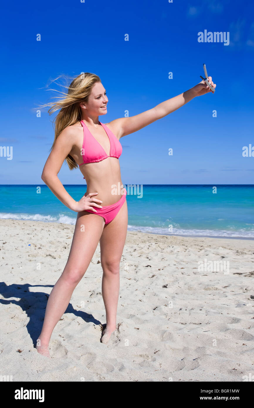 portrait of teenage girl in bikini sitting in the water Stock