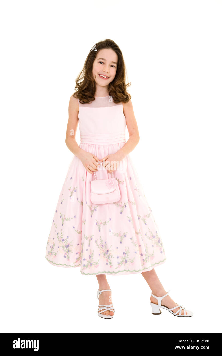 Young caucasian girl dressed in a Easter dress and standing on a white  background Stock Photo - Alamy
