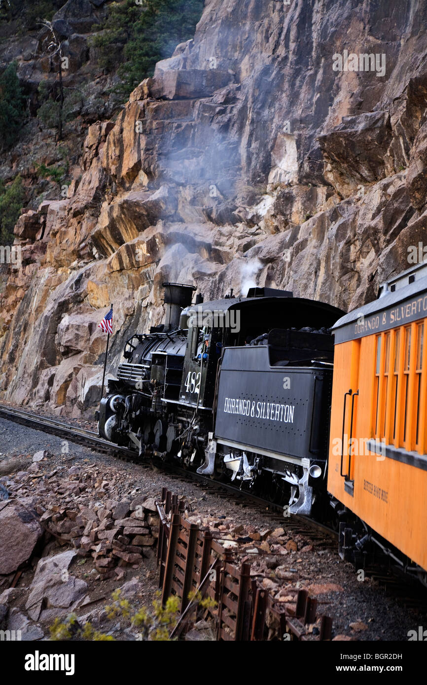Historic narrow gauge Durango-Silverton railway steam train with steep cliffs Cascade Canyon, Colorado USA Stock Photo