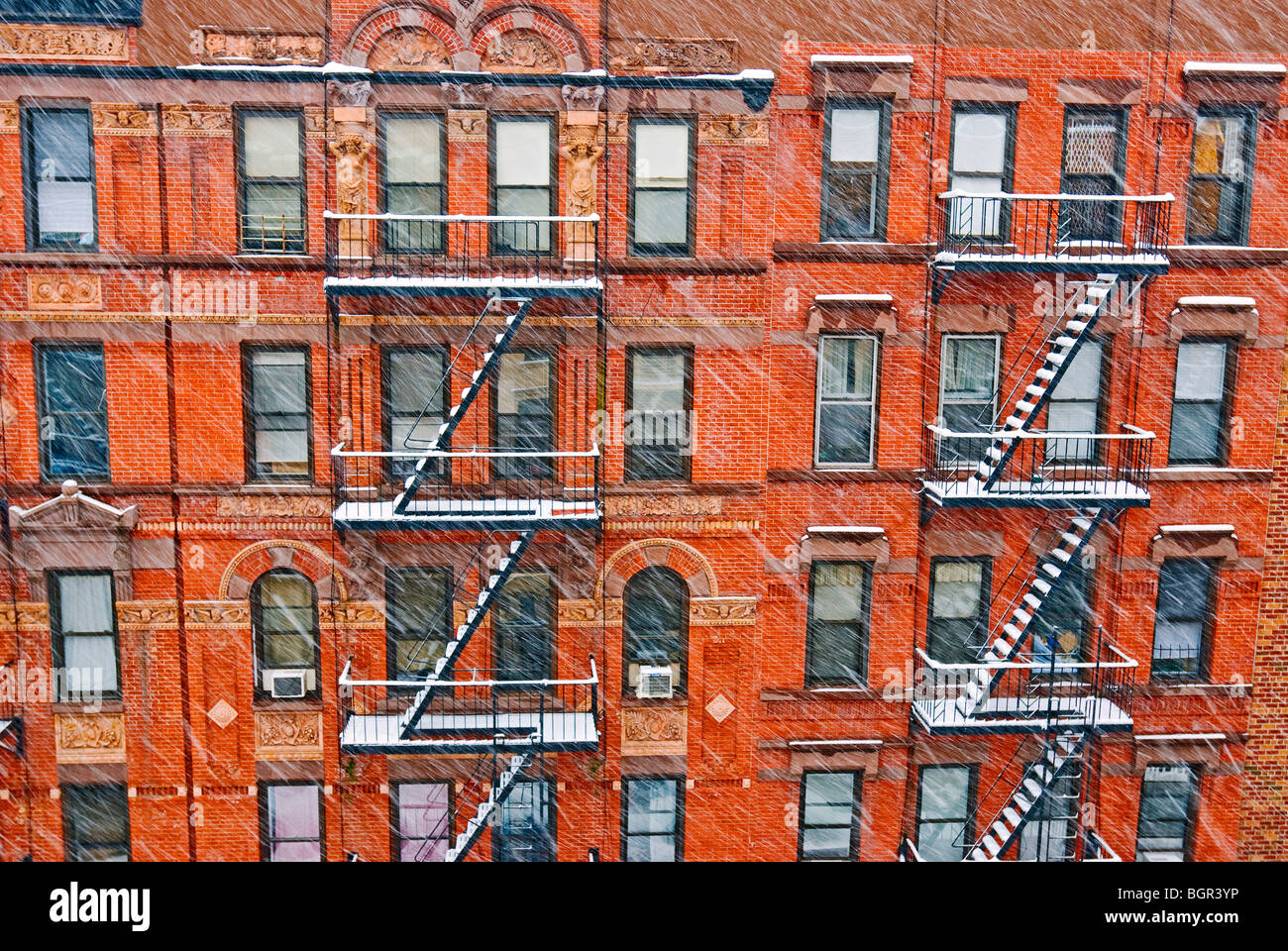 Tenement apartment buildings in New York City during winter snowstorm. Stock Photo