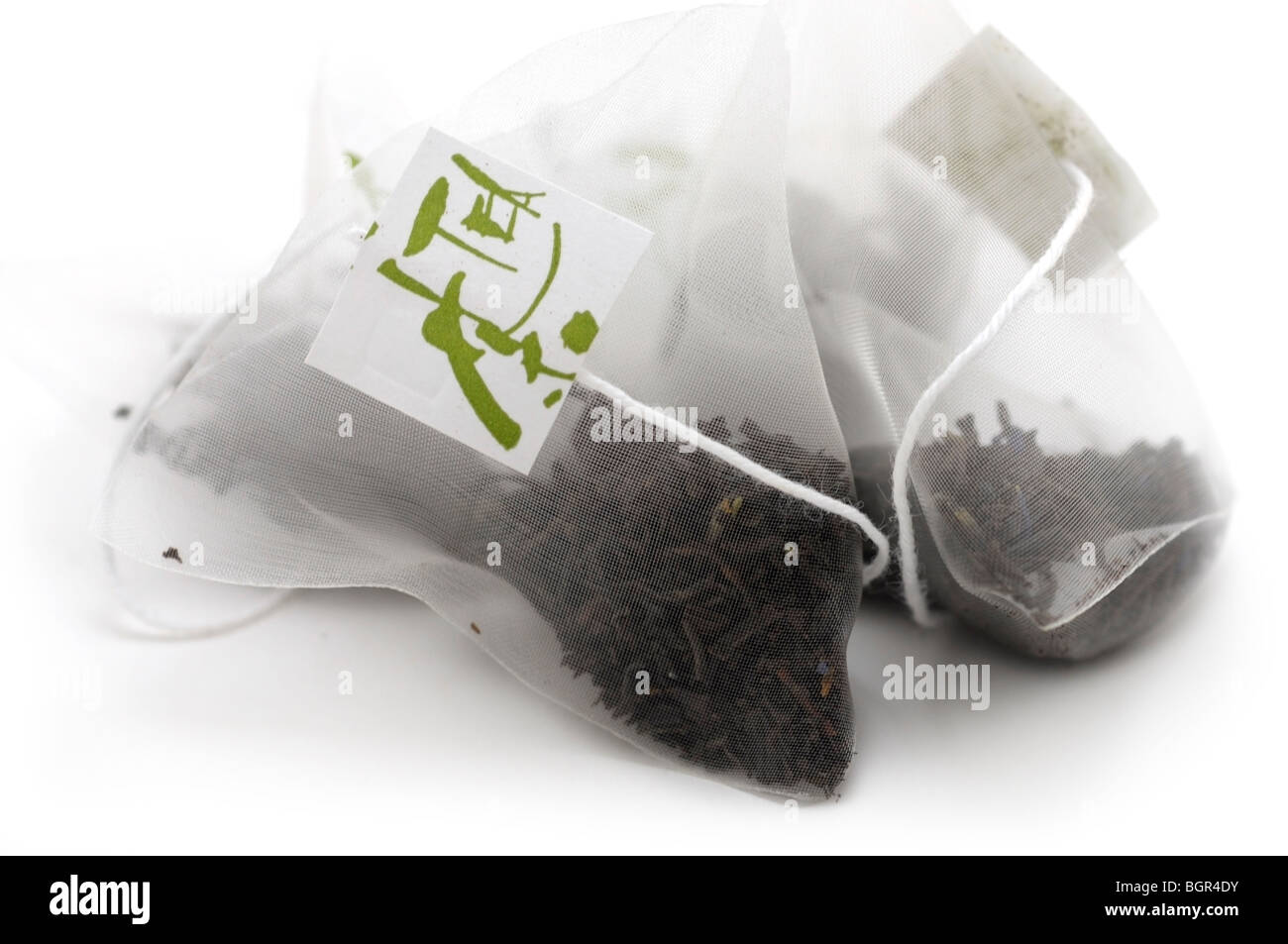 Teabags with Black Tea Leaves Stock Photo